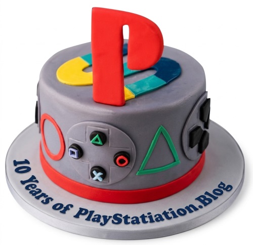 Round grey PlayStation themed birthday cake with controller buttons and a large red 'P' on top.