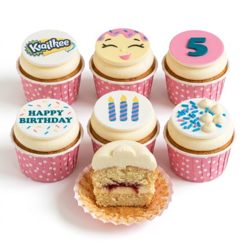 Six colourful kids birthday cupcakes with custom age topper, emoji, candles, and sprinkles in pink wrappers.