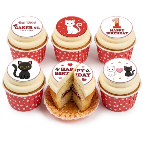 A selection of cupcakes with white frosting and red polka dot cases, topped with cute white and black cat designs, hearts, paw prints, and 'Happy Birthday' messages, including a '1' topper.
