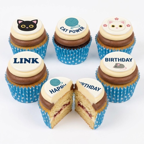 A set of cat-themed birthday cupcakes with various edible toppers including cat faces, a yarn ball, a mouse, and custom messages.