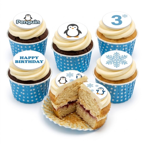 Penguin themed birthday cupcakes with white frosting, blue polka dot wrappers, and custom age and message toppers.