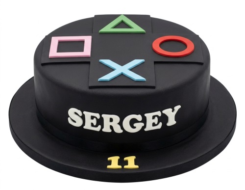 Round black cake with PlayStation controller symbols and custom name and age.