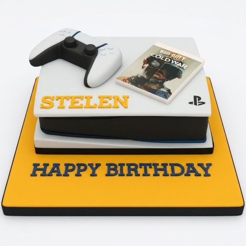 White and black PS5 console shaped birthday cake with a white controller and game case.