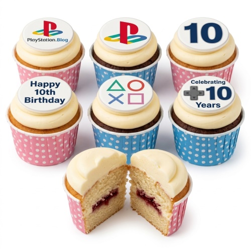 PlayStation themed cupcakes with white frosting, featuring gaming logos and symbols on edible toppers in pink and blue cases.