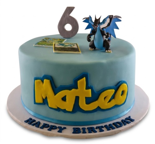 Light blue single-tier Pokemon birthday cake with Charizard figure, trading cards, custom name, and age topper.