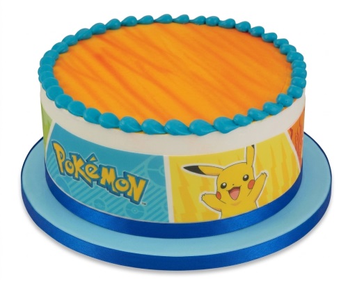 Round Pokémon birthday cake with Pikachu design and blue icing border on a blue board.