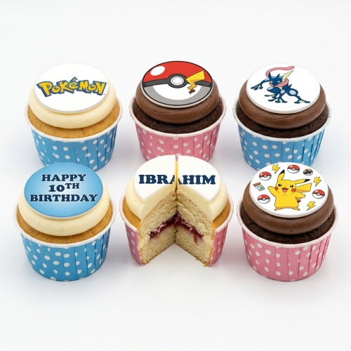 Assorted Pokémon themed cupcakes with Pikachu, Poké Ball, Greninja, and Pokémon logo toppers, featuring a custom age message.