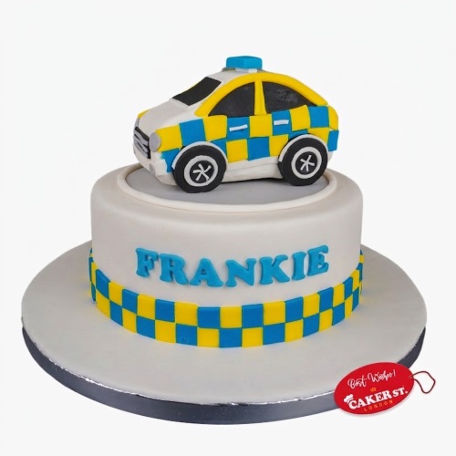 White single-tier birthday cake with a blue and yellow checkered band, topped with a 3D police car and a personalised name.