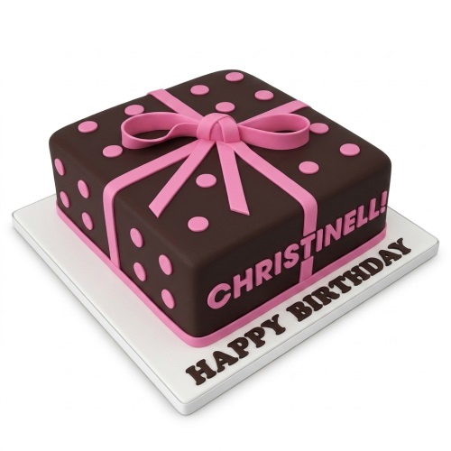 Square brown cake with pink ribbon, bow, and polka dots, featuring a custom birthday message.