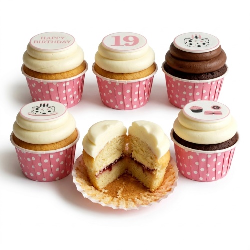 Set of pink polka dot birthday cupcakes with white and chocolate frosting, featuring 'Happy Birthday', custom age '19', and cake toppers.