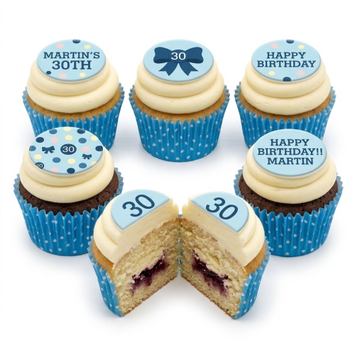 Set of blue and white polka dot cupcakes with cream frosting and custom age bow tie and birthday toppers.
