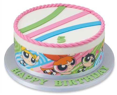 Round white Powerpuff Girls birthday cake with green, pink, blue stripes and a pink twisted border, featuring a custom age topper and "Happy Birthday" message.