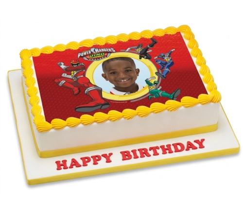 Rectangular Power Rangers Dino Charge birthday cake with a custom child's photo and yellow icing.