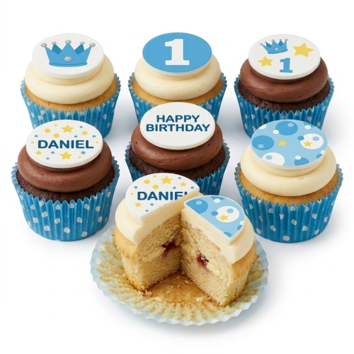 Set of blue and white 1st birthday cupcakes for boys with crown and number 1 toppers.
