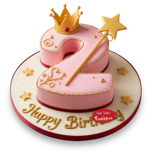 Pink number 2 birthday cake for a girl, decorated with a gold crown, magic wand, and 'Happy Birthday' message.