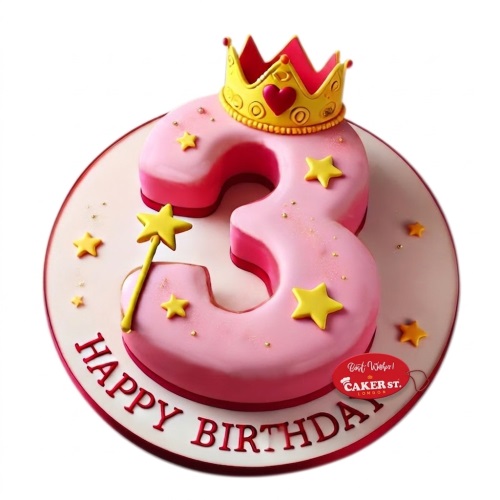 Pink number shaped birthday cake with a gold crown, yellow stars, and a magic wand.