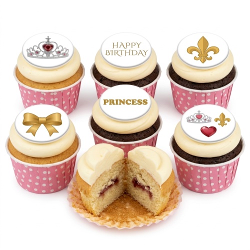 Six cupcakes in pink polka dot cases with white frosting and princess-themed edible toppers including crowns, a gold bow, a fleur-de-lis, a heart, and text "HAPPY BIRTHDAY" and "PRINCESS".