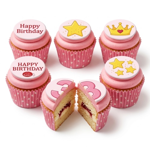 Pink cupcakes with stars, crown, and 'Happy Birthday' toppers, one with a number three.