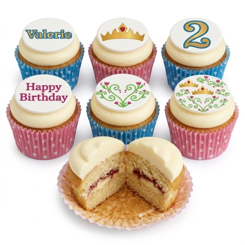 Vanilla cupcakes with white frosting, decorated with gold crowns, floral designs, 'Happy Birthday', 'Valerie' and a number '2' topper.