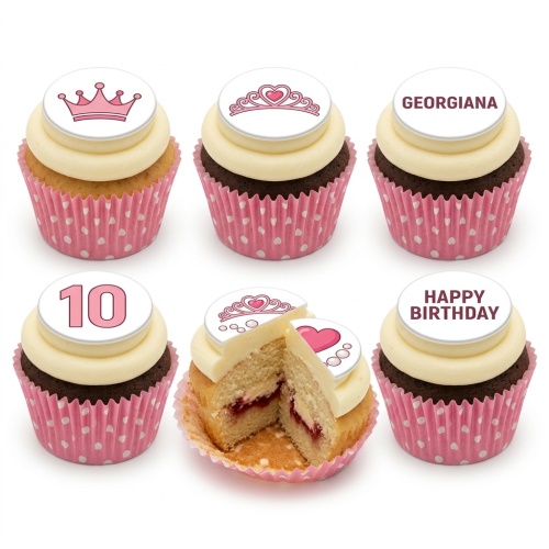 Set of six cupcakes with pink princess crown and tiara toppers, one with '10', one with 'Georgiana', and one with 'Happy Birthday'. Pink polka dot cases.