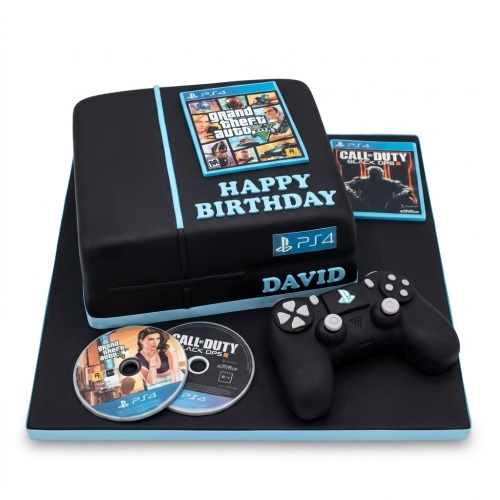 Black PlayStation 4 console cake with controller, Grand Theft Auto and Call of Duty game covers.