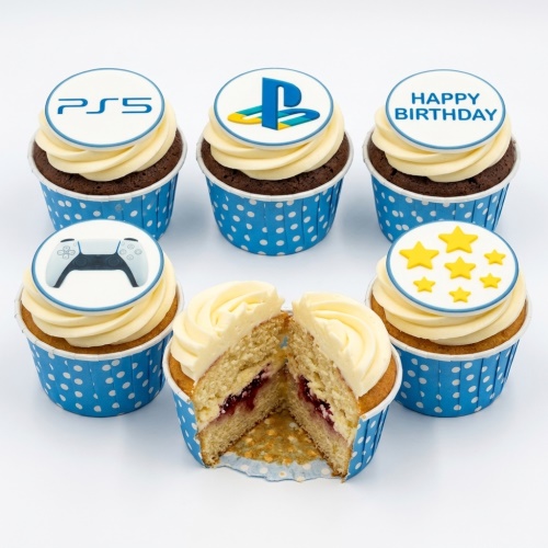 Six cupcakes with PS5, PlayStation logo, controller, Happy Birthday, and star toppers in blue cases.