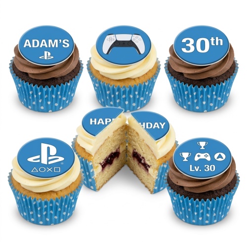 PlayStation themed cupcakes with blue wrappers, white and chocolate icing, featuring PS5 controller, logo, and custom age/name toppers.