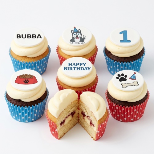 Assortment of dog-themed birthday cupcakes with white frosting, including a husky, paw print, and dog bowl designs.