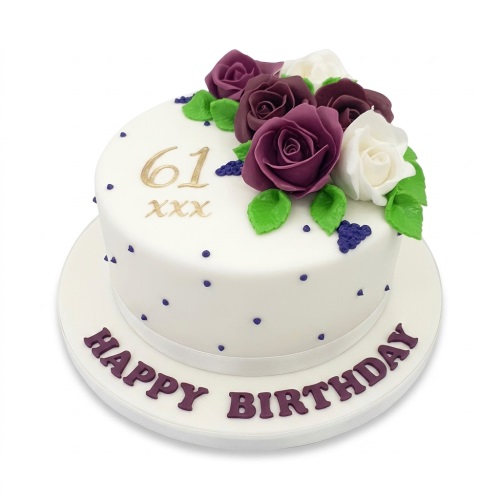 Elegant white round birthday cake with purple and white sugar roses, green leaves, purple polka dots, and a gold custom age topper.