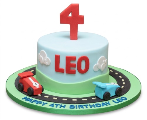 Round light blue and green cake with red and blue racing cars, a road, clouds, and a red number four topper.