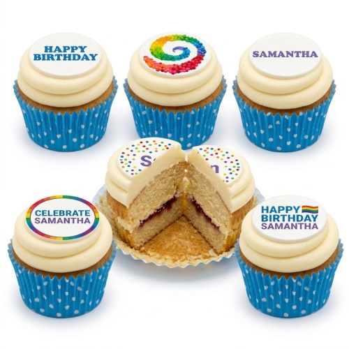 Six cupcakes with white frosting and blue polka dot cases. Toppers show rainbow swirls, 'Happy Birthday', 'Samantha', and 'Celebrate Samantha'. One cupcake is cut, revealing jam filling.