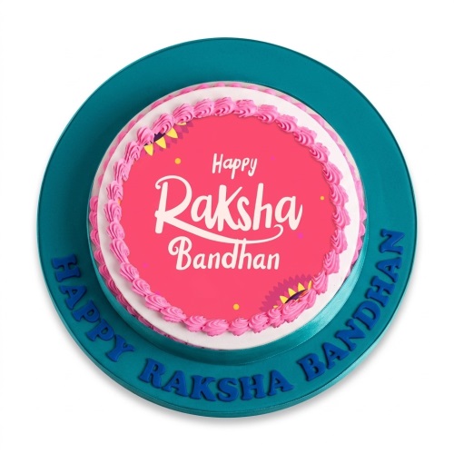 Round single-tier cake with 'Happy Raksha Bandhan' message on pink top and teal base with ribbon.