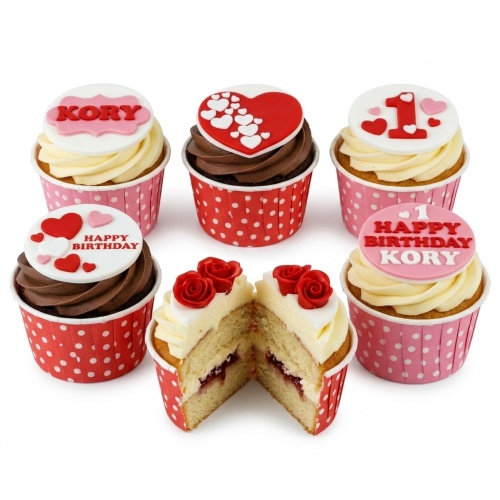 Assortment of red and pink heart birthday cupcakes with custom age and name toppers.