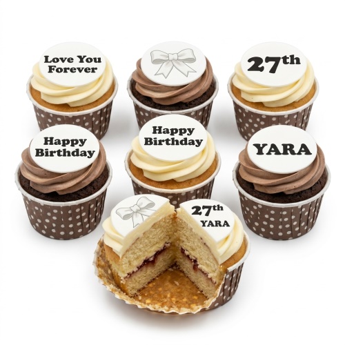 Assortment of birthday cupcakes with white fondant toppers, some with a bow design, others with custom age, name, and messages.