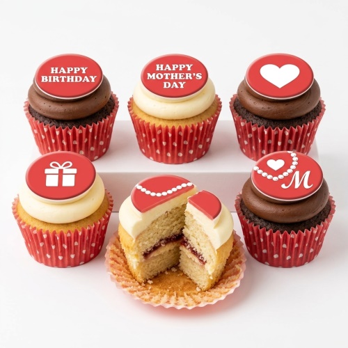 Assortment of elegant cupcakes with red toppers, including 'Happy Birthday', 'Happy Mother's Day', heart, gift, and a pearl necklace with initial 'M'.