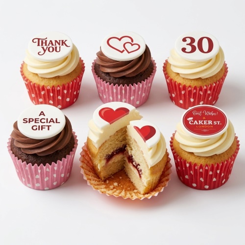 Assortment of vanilla and chocolate cupcakes with white and red custom message and heart toppers.