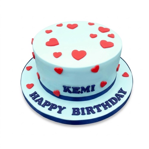 Light blue birthday cake with red fondant hearts and a dark blue ribbon.