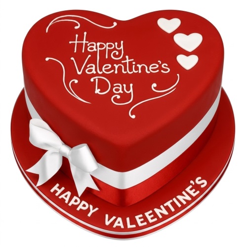 Red heart-shaped cake with 'Happy Valentine's Day' message, white ribbon, bow, and small white hearts.