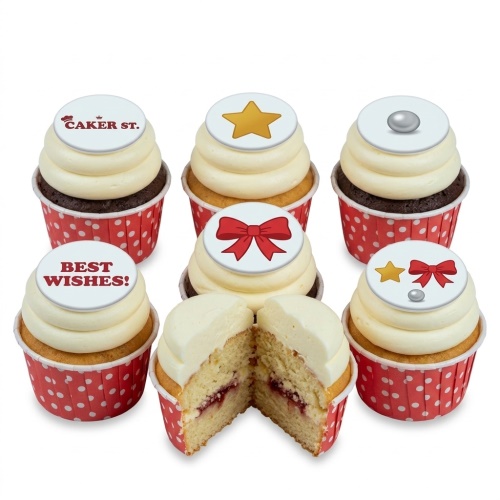 A selection of cupcakes with white frosting and red polka dot cases, topped with edible stars, bows, a pearl, and a 'BEST WISHES!' message.