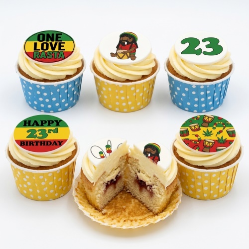 Six cupcakes with white frosting, Rasta-themed edible toppers, and polka dot wrappers. One cupcake is cut open.