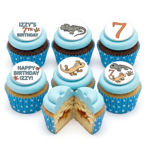 Cupcakes with blue frosting and edible lizard toppers, some with custom age and personalised name.