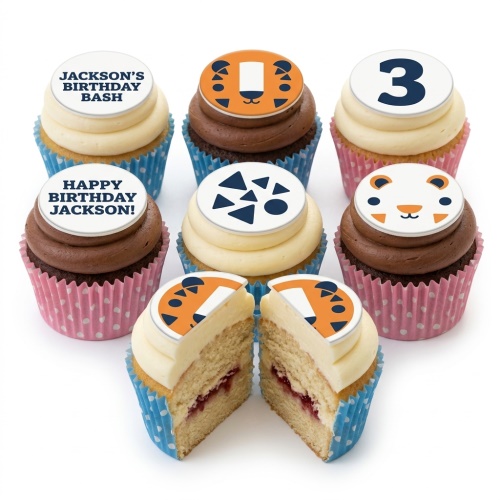 Jungle theme cupcakes with tiger faces, geometric patterns, and a custom age topper.