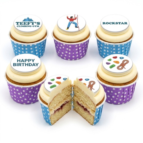 Vanilla cupcakes with rock climbing themed edible toppers, blue and purple polka dot wrappers.