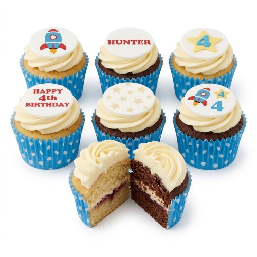 Vanilla and chocolate cupcakes with white frosting, decorated with rocket, star, and custom age toppers in blue polka dot cases.