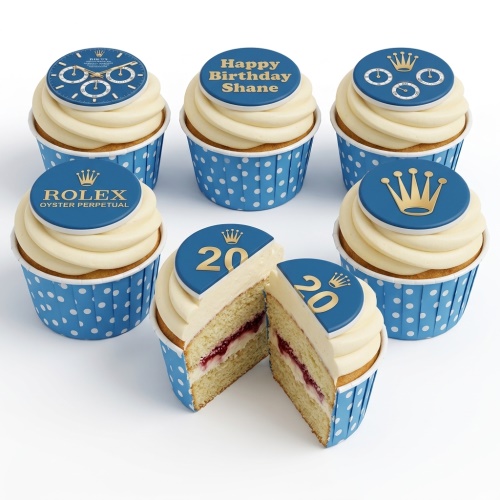 Six Rolex theme cupcakes with blue and gold toppers, white frosting, and polka dot wrappers, including a custom age topper.