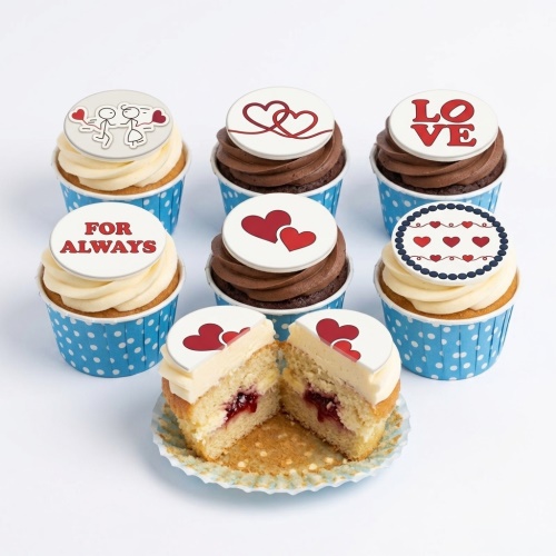 Assortment of love heart cupcakes with romantic toppers and messages