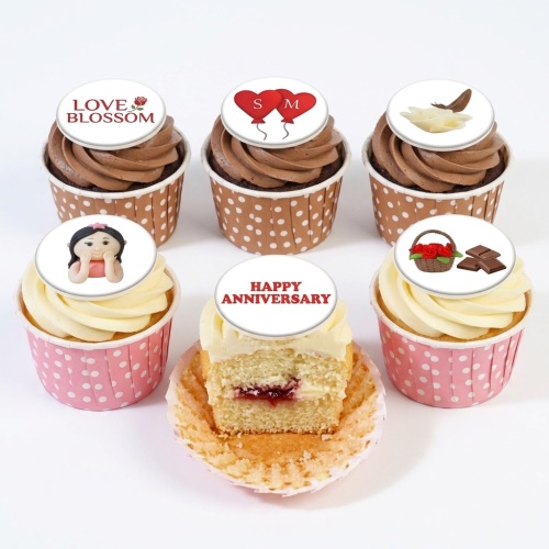 Assortment of anniversary cupcakes with chocolate and vanilla frosting, topped with love-themed and custom message edible toppers.