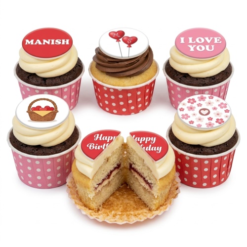 Assortment of birthday and love-themed cupcakes with custom message toppers in red and pink.