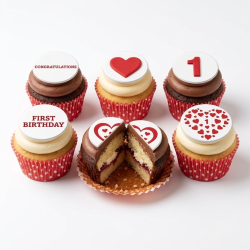 Six cupcakes with red and white toppers, featuring hearts, the number 1, and 'First Birthday' messages.