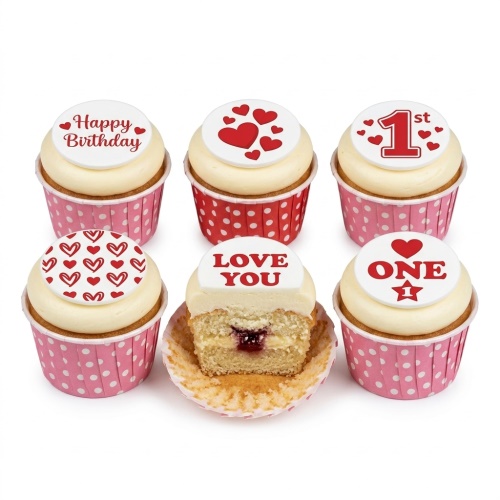 1st Birthday cupcakes with heart, '1st', and 'Happy Birthday' toppers in pink and red cases.